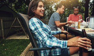 woman smiling while seated outdoors