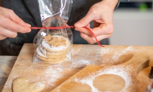 Woman baking at home: Preparing bag of cookies