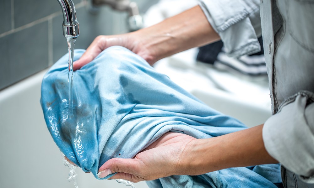 rinsing out stain on blue fabric