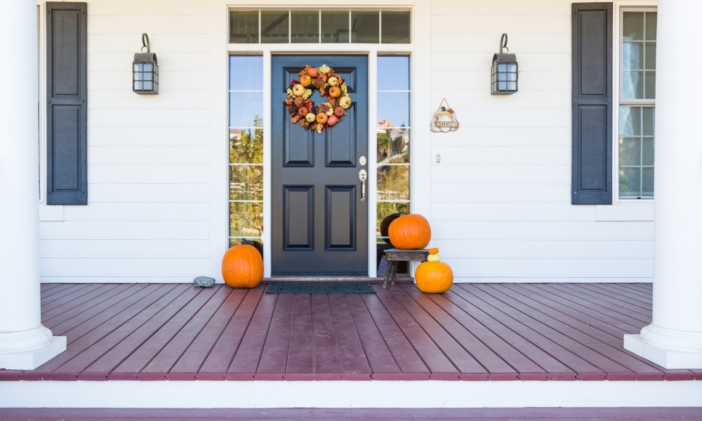 Fall front door decor with a wreath and pumpkins