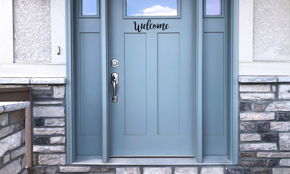 Blue door with "Welcome" sign