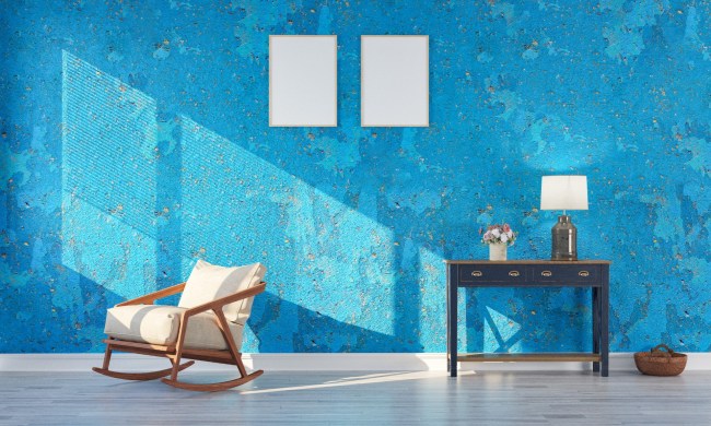 Sunny living room with blue wall, chair, and desk