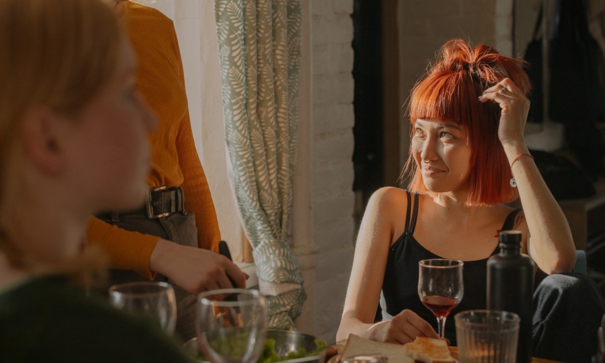 Woman sitting at a table with friends during party