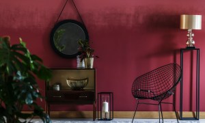 Modern black furnishings against cranberry red wall