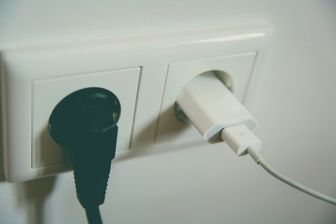 Black and white plugs in electrical outlet