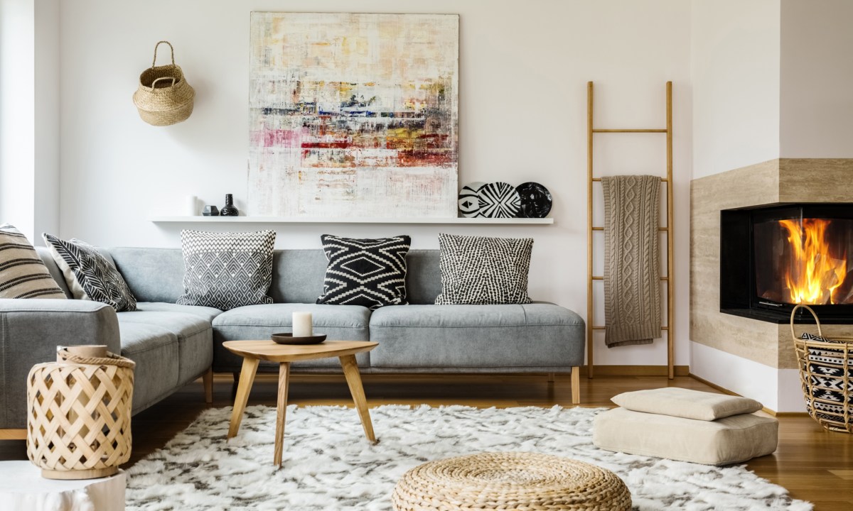 Living room with couch, rug, and fireplace