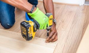 Man drilling hole in wood