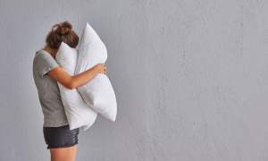 Woman hugs pillows