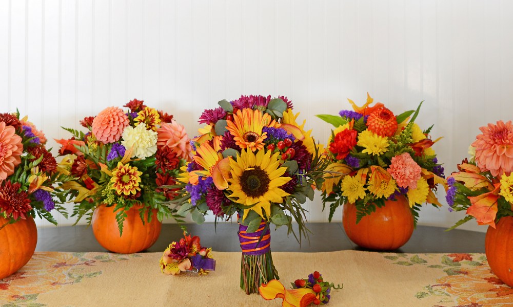 Pumpkins and fall flowers arranged for fall centerpieces