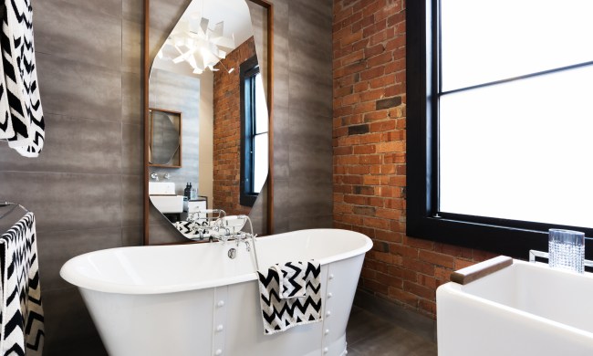 Bathroom with tile and brick wall