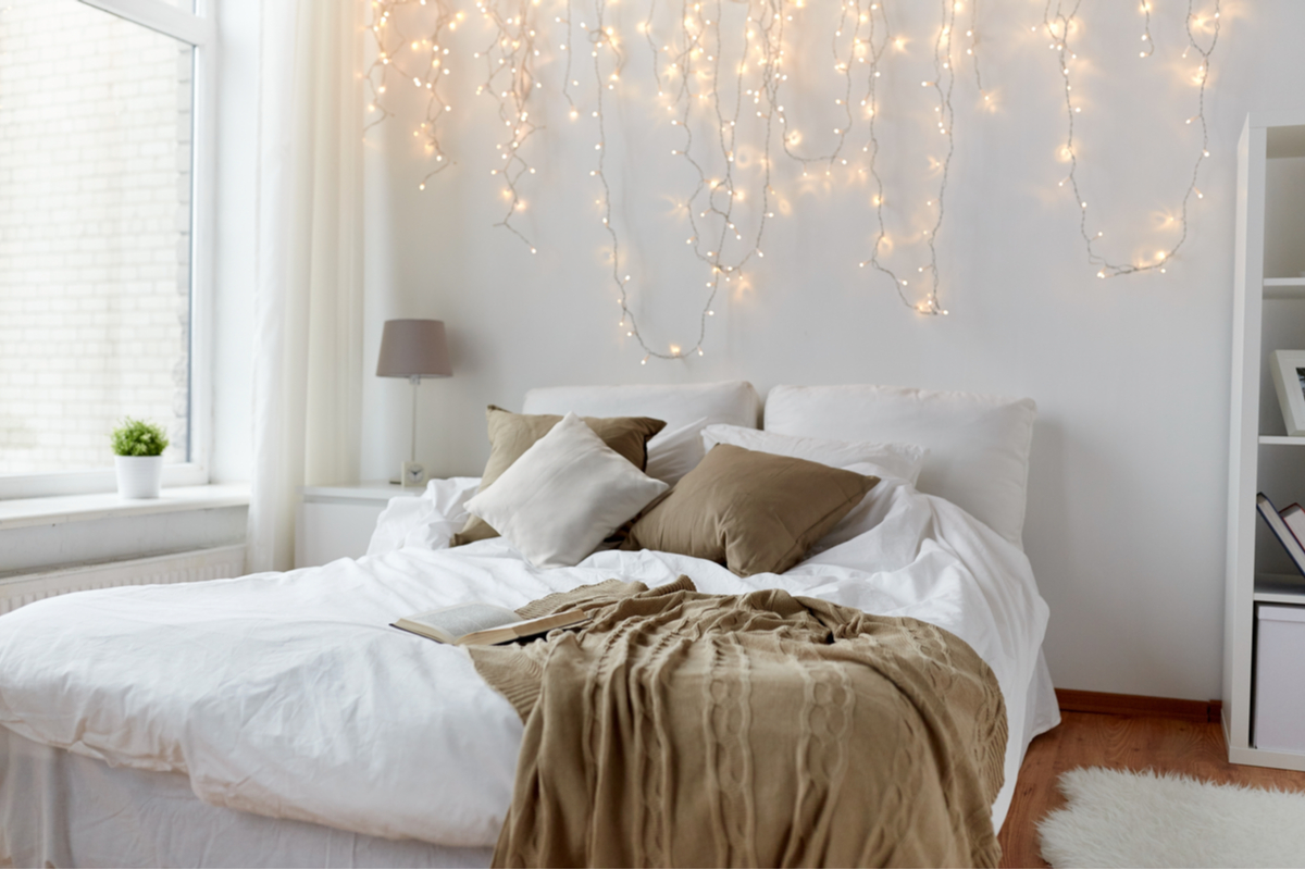 Cozy neutral bed with fairy lights