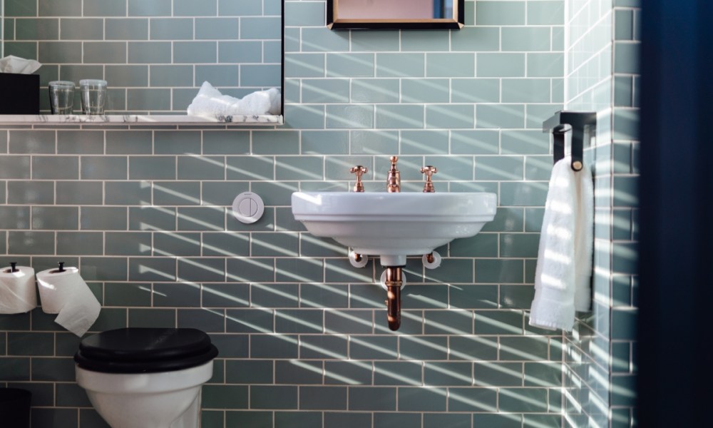 Small bathroom with blue tiles and floating sink