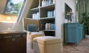 Reading nook in a bedroom with cozy chair and ottoman