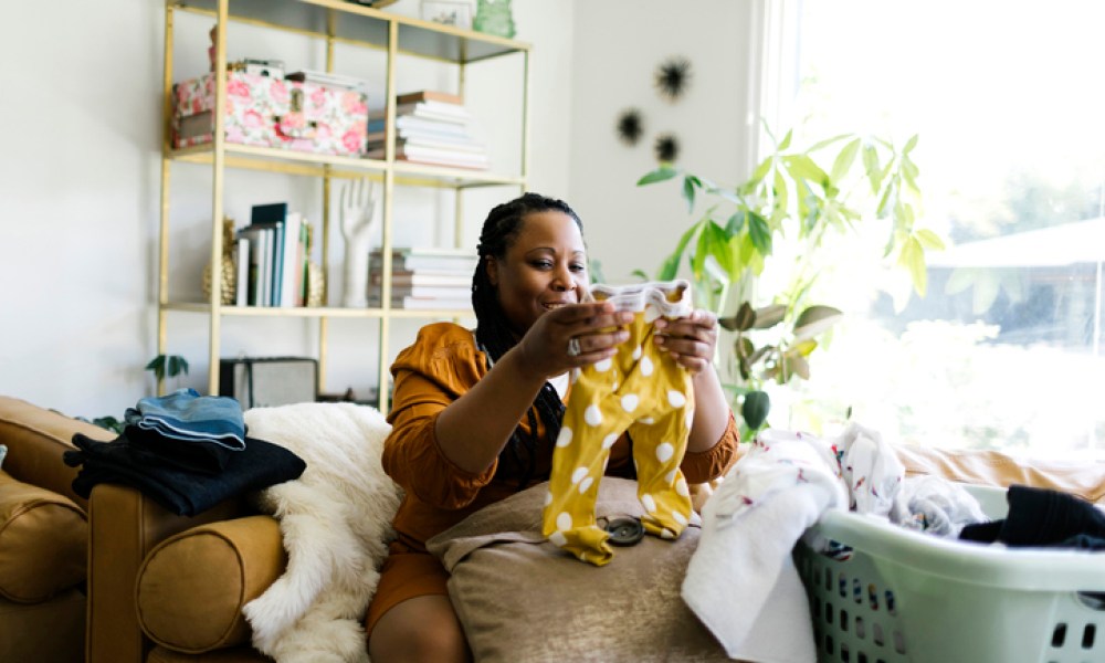 Woman folding laundry in living room