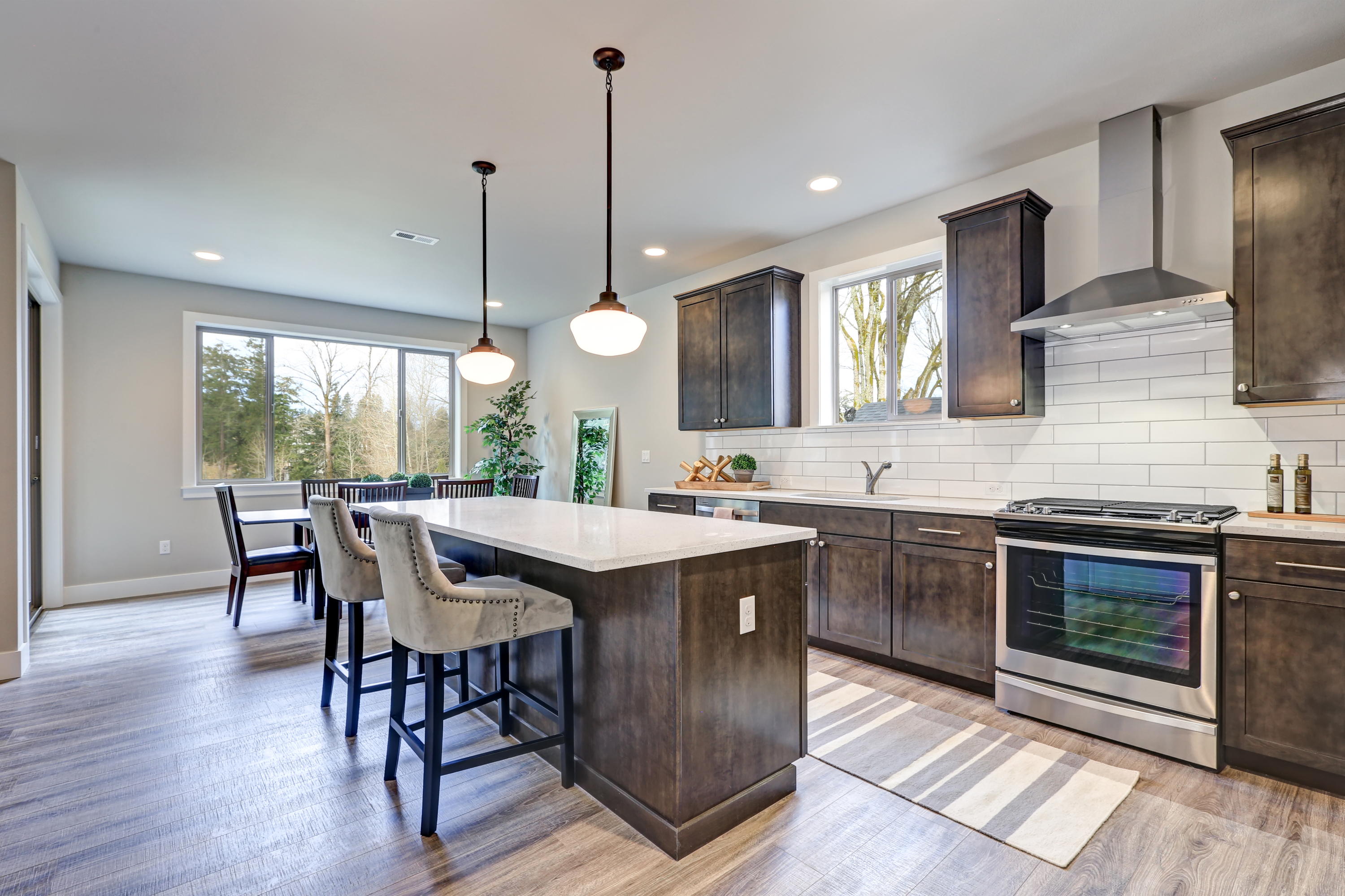 large modern kitchen with subway tile and wood cabients