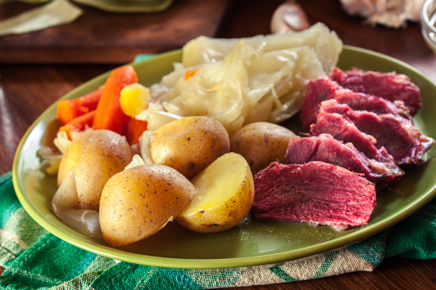 Plate of corned beef and cabbage on table.