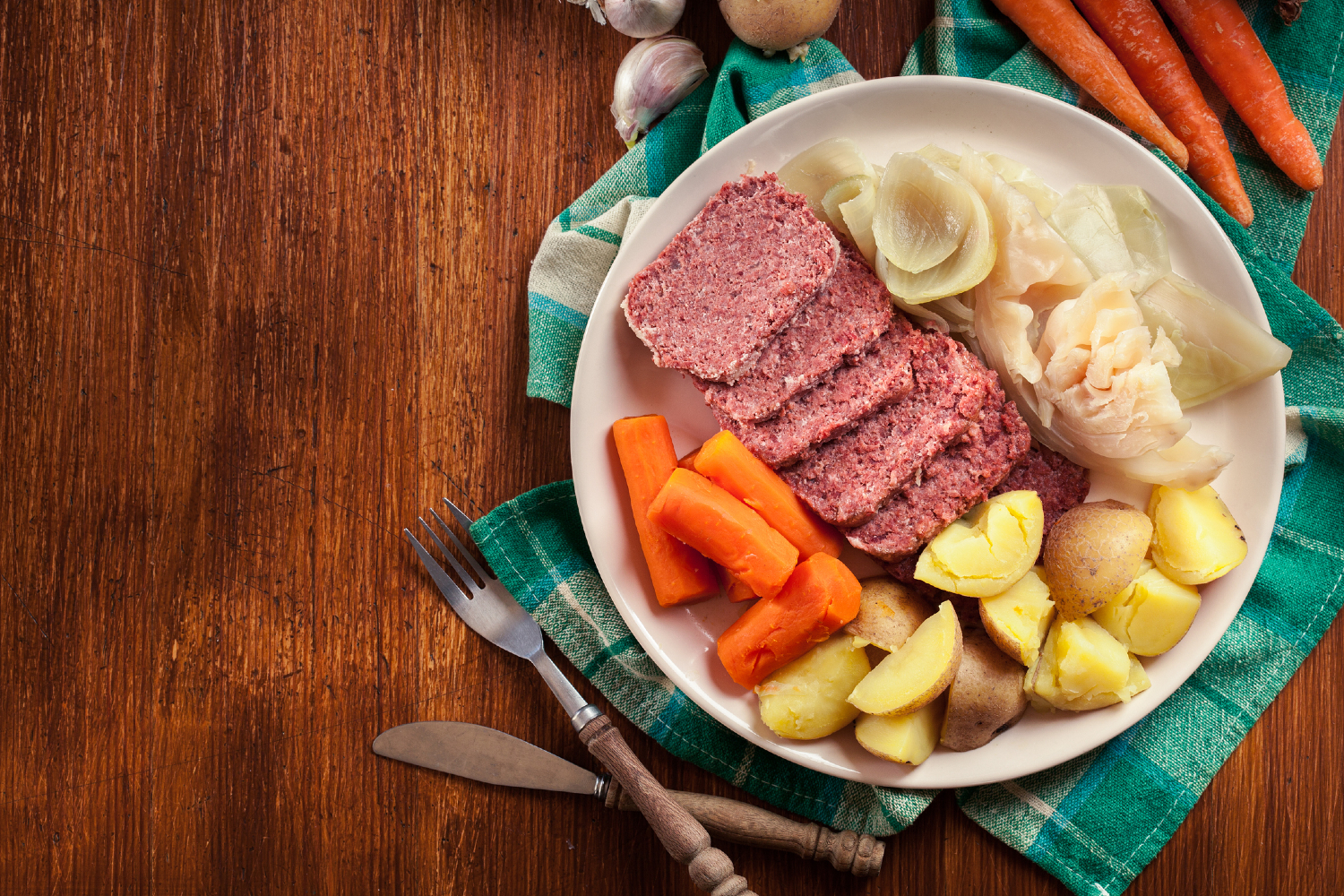 corned beef and cabbage recipe on plate with green napkin resized