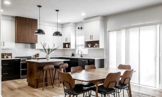 Kitchen with black cabinets and dark wood inspired by midcentury design