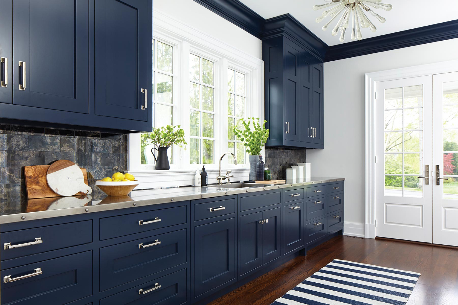 blue kitchen cabinet with green wall