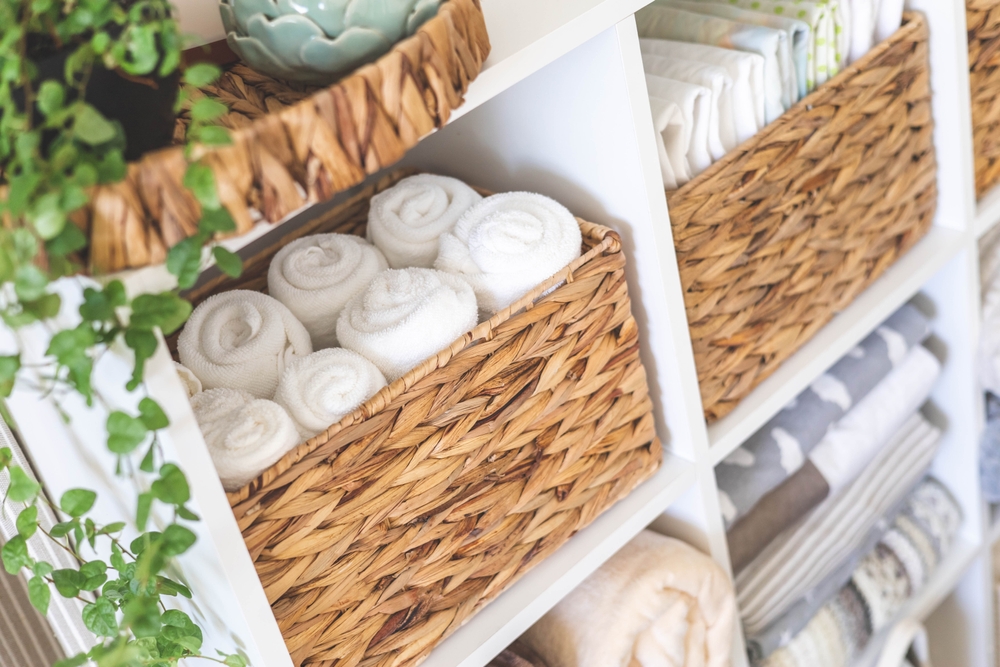 how to organize bathroom storage cabinet natural textile rolled up towels in mesh basket placed on