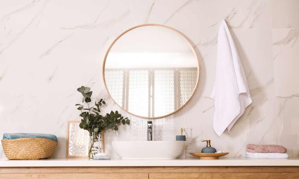 Modern bathroom with round mirror