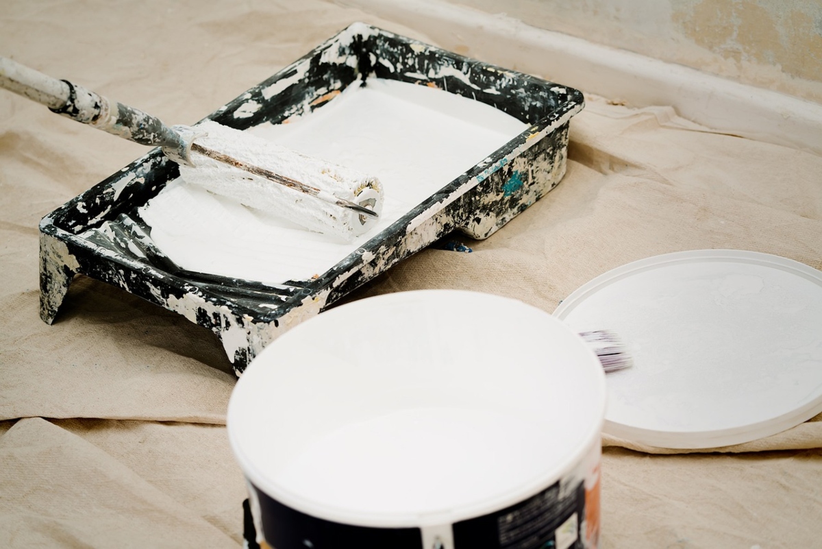 White paint in paint tray with a roller