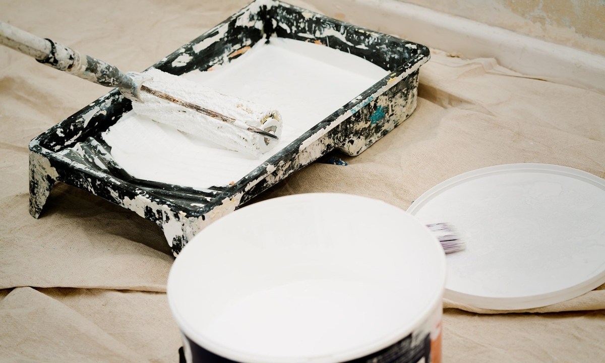 White paint in paint tray with a roller