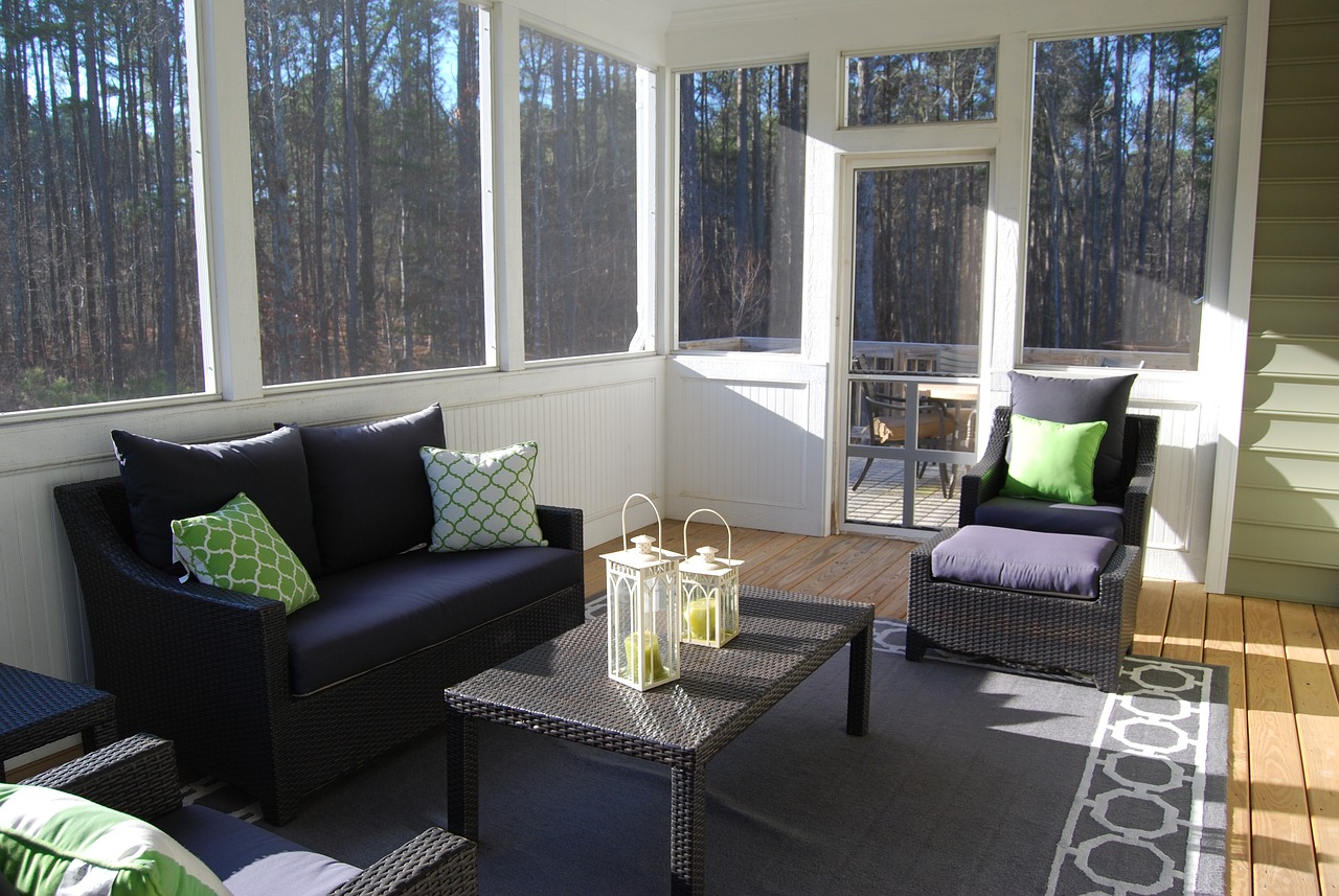 sunroom porch with dark furniture and white trim