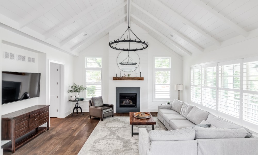 All-white modern farmhouse living room with a beadboard ceiling