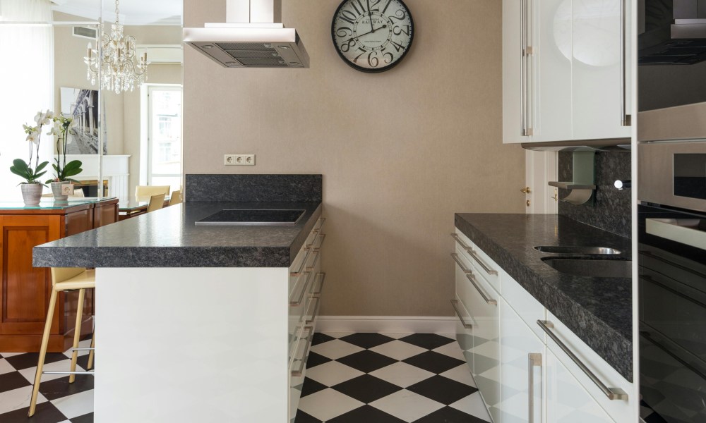 midcentury modern kitchen with black and white tile floor and granite countertops