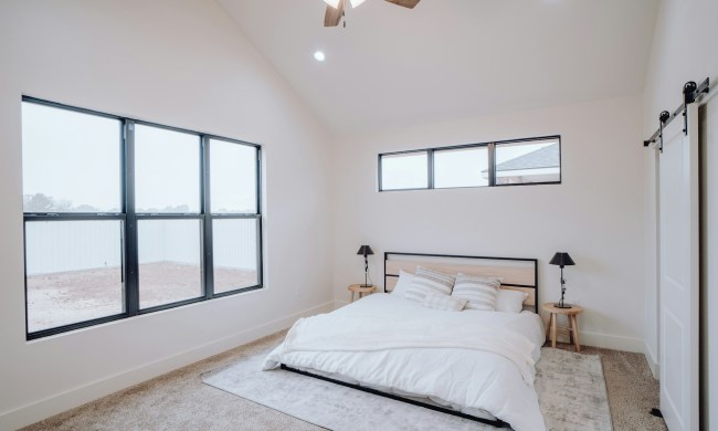 White bedroom with a vaulted ceiling