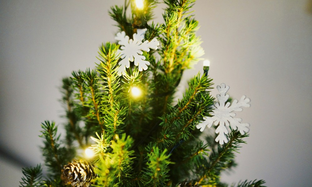 Top of christmas tree with lights and snowflake ornaments