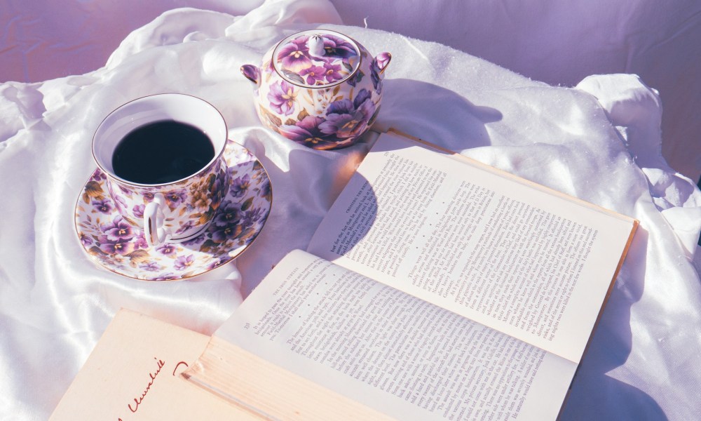 Bone china on white fabric next to a book