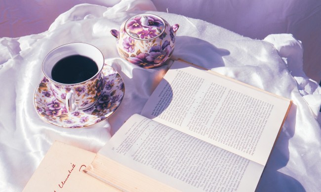 Bone china on white fabric next to a book